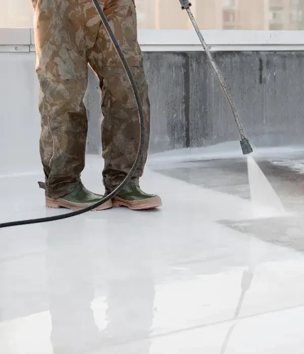 Pressure washing technician using equipment on a clean surface, demonstrating professional cleaning services for residential exteriors in Indian Trail, NC.